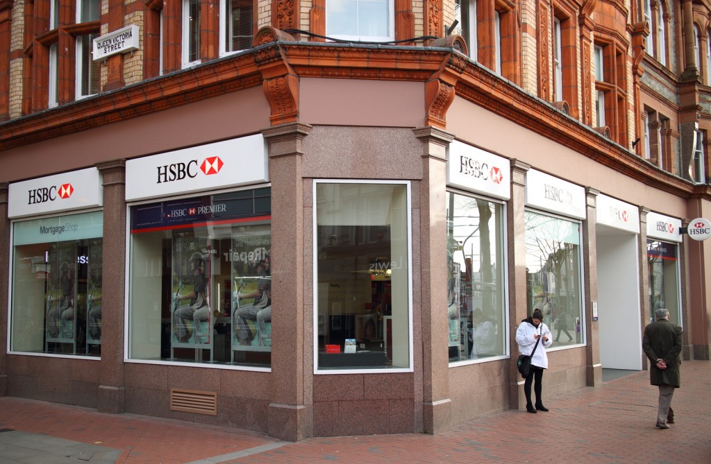 Reading, England - March 6, 2015: People in front of the HSBC Bank in Reading, England. The Hong Kong and Shanghai Banking Corporation was founded in 1865 to finance trade between Asia and the West